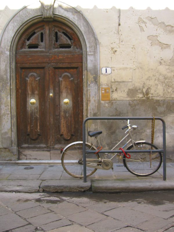 KarensItaly_090403_1025.jpg :: Classic photo of bike locked up and apartment door with door knobs in center of doors. (A3:4) (LE2k)