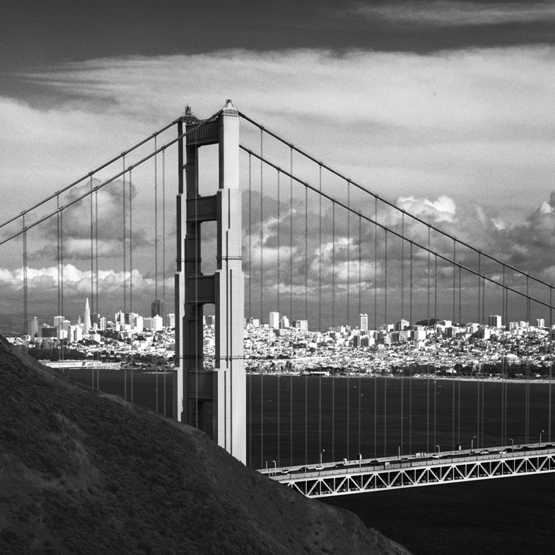 San Francisco - City by the Bay.jpg :: Iconic view of San Francisco through the North Tower of the Golden Gate Bridge. The exposure was made at 5:20 PM on March 17, 2006 mid-span on the Golden Gate Bridge in San Francisco. It was made on Kodak TMax 100 film in a Hasselblad 500C/M through a 100mm lens behind a 13 yellow filter.  The lens aperture was set at f/22 with a 1/4 secnd shutter speed. 