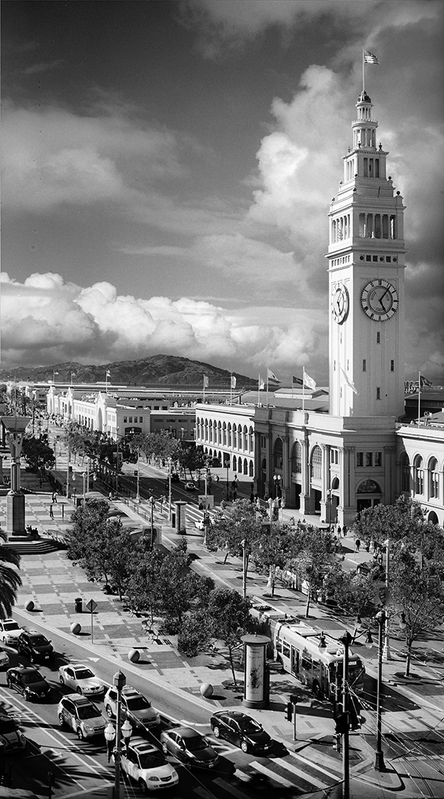 San Francisco -- Justin Time -- vertical panorama.jpg :: The exposures (two negatives) of the Ferry Building on Justin Herman Plaza were made at 5:07 PM on May 18, 2019 from the roof deck of the Hotel Vitale on the Embarcadero in San Francisco.  They were made on Kodak TMax 400 in a Hasselblad 500 C/M through a 100MM lens behind a yellow filter. The lens was set at an aperture of f/5.6 at a shutter speed of 1/125 of a second.

I digitized the negatives in a high-resolution film scanner and then merged the two files electronically and post-processed them to produce the cropping, tonal range and local contrasts which the image manifests.