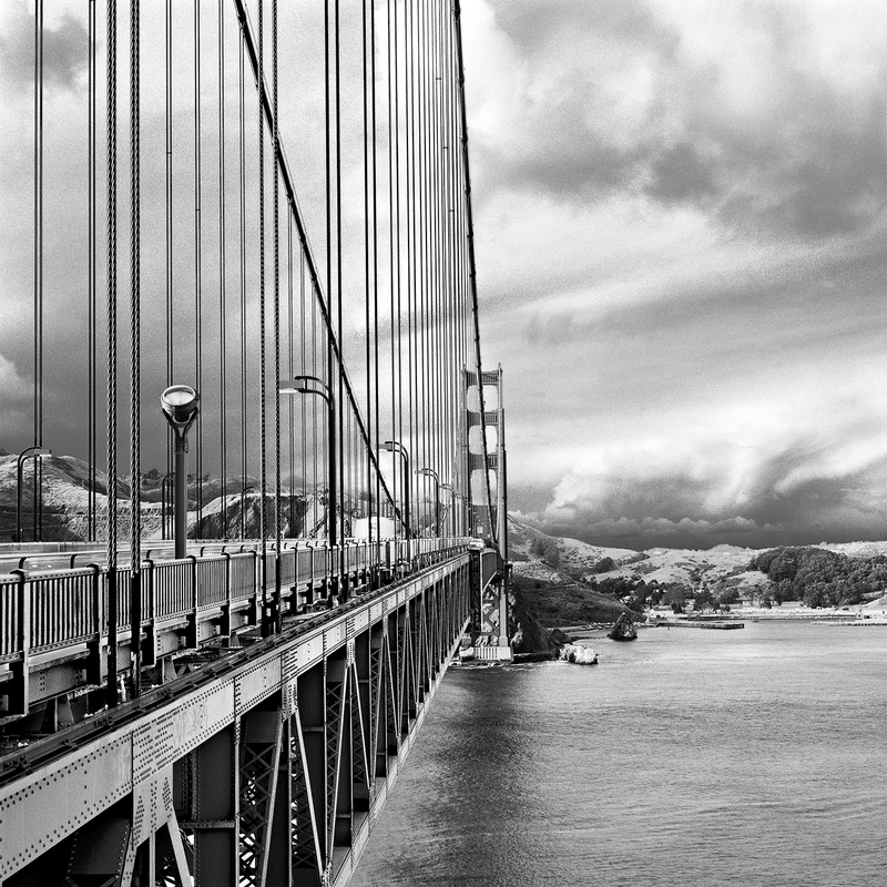 San Francisco--Clearing Storm at Golden Gate.jpg :: The Golden Gate Bridge from the south tower looking into Marin County over the Marin Headlands. Exposed at 5:20 PM on March 17, 2006 through a 100 mm lens on Hasselblad 500 CM using TMax 100 film at f22 and 1/4 of a second with a deep red filter.    To see a rectangular version of this image, click on \