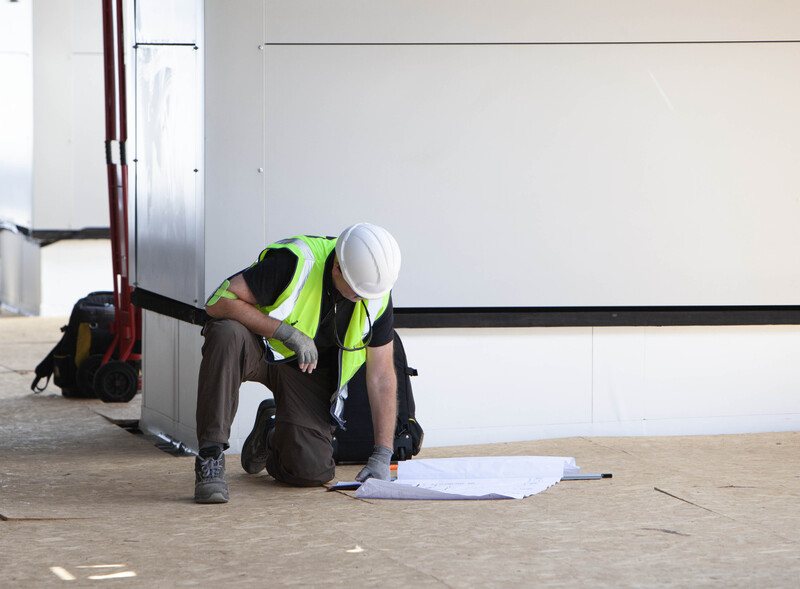 Project Planning  Blueprint Consultation.jpg :: Documenting the consultation process in a live project environment. This image emphasizes the planning, review, and adherence to technical drawings required on major construction sites.