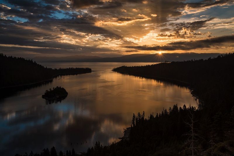 DAYBREAK.jpg :: EMERALD BAY - LAKE TAHOE, CALIFORNIA.   
Storm clouds slowly part to make way for the first rays of light over Lake Tahoe as the glassy kaleidoscope of Emerald Bay silently reflects the quickly changing sky.
