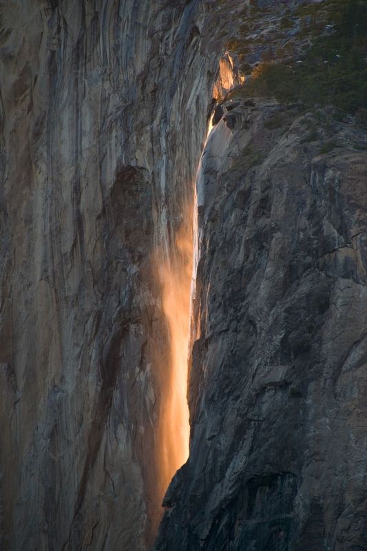 FIREFALL.jpg :: HORSETAIL FALLS, YOSEMITE NATIONAL PARK, CALIFORNIA.     
The last rays of sunlight pierce across the tremendous vertical face of El Capitan, intensely illuminating the blowing mist of Horestail Falls. 
This image captures the final moments of sunset, the vertical straked granite, and the windblown mist of Horsetail Falls. 
On any given year, this fleeting combination of natural events may only happen a few times or not at all. 