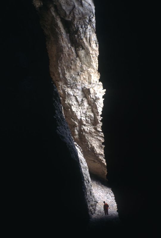 JARBIDGE CAVE.jpg :: JARBIDGE RIVER GORGE, IDAHO.    
A solitary figure contemplates the entrance to one of many large caves found in twisted vertical walls of the Jarbidge River Canyon 

