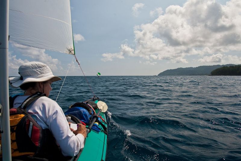 JOURNAL TIME.jpg :: CAROLINE BAY - MALEKULA ISLAND, VANUATU.  With rough seas of Ambrym and Malekula Islands of Vanuatu behind us, Carrie takes time during the long sail to catch up on journaling. 
