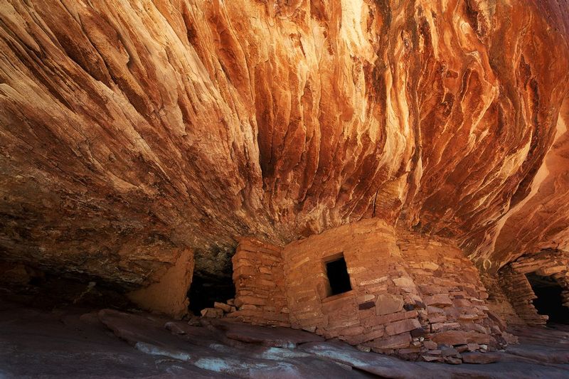 MULE CANYON HOUSE ON FIRE.jpg :: CEDAR MESA REGION - UTAH.     
Light reflects down into an ancient ancestral Pueblo dwelling and associated granaries interwoven into a non-descript slickrock alcove in the Cedar Mesa wilderness area of Utah. 
The intense reflected light from the surrounding red rock creates a dramatic illusion of fire frozen into solid stone.