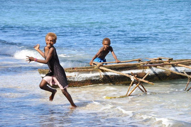 PLAY TIME.jpg :: VILLAGE OF VUTEKAI.  ISLAND OF PAAMA, VANUATU.   In the rural villages of Vanuatu, there are no toys, little or no electricity, and there are no social distractions common in the western experience. The children of Vanuatu live a simple, and somehow, perfect social existence. When not working to help parents or siblings, children find time to play together in pairs and in small and large groups. In every case we witnessed, the play and interaction of the children was simple, complete, and without prejudice. The children of the modern western world could learn much from the children of Vanuatu.