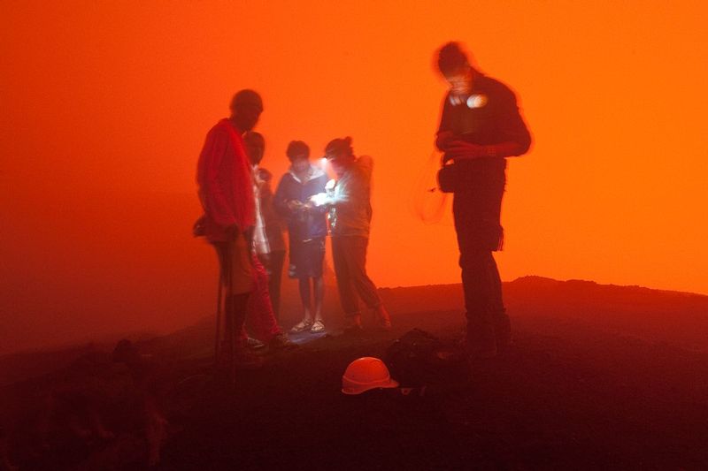 PREPARING FOR MT MARUM.jpg :: MOUNT MARUM, ISLAND OF AMBRYM, VANUATU.  At the summit of the volcano, the team adjusts their gear and prepare to approach the edge of the caldera rim perched over 1,000 feet above the boiling lava pools which light the sky and the sulphuric gases.