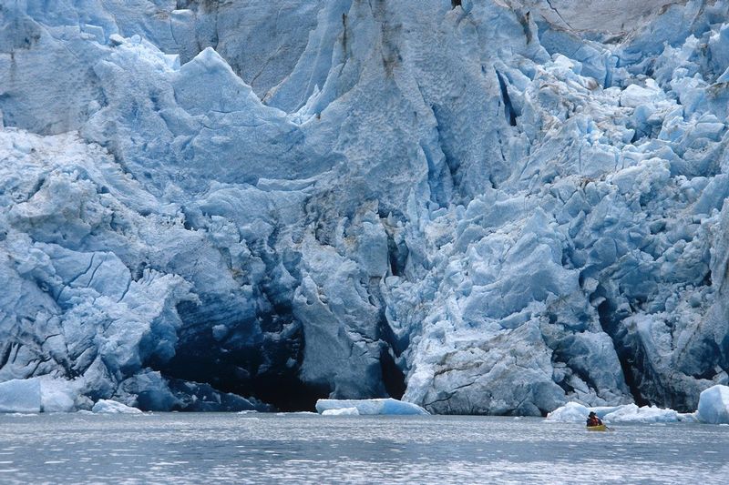 REID GLACIER.jpg :: GLACIER BAY NATIONAL PARK, ALASKA.     
A lone sea kayaker paddles near the intensely sculpted blue face of Reid Glacier 


