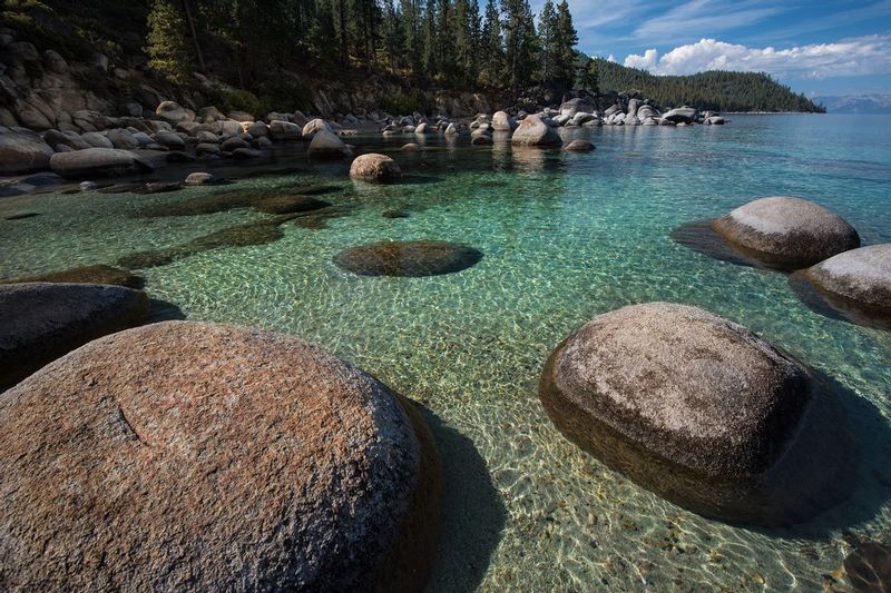 SECRET HARBOR.jpg :: SECRET HARBOR - LAKE TAHOE, NEVADA
Early morning peeks over Spooner Summit and spills light onto the peaceful water, granite boulders and course-grained sand at Secret Harbor.   