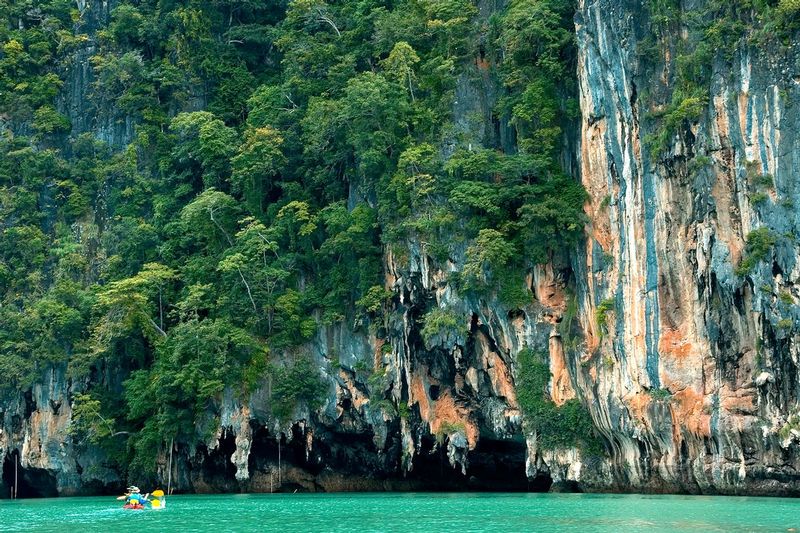 SERENITY AT TALABENG.jpg :: Andaman Sea, Thailand     
Sea kayakers are dwarfed by the size and the silence of the limestone cliffs of Ko Talebeng.