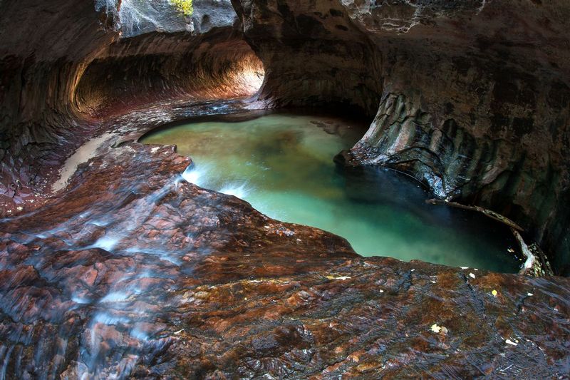 SUBWAY CANYON.jpg :: SUBWAY CANYON - ZION NATIONAL PARK, UTAH.     
A difficult journey into the slot canyon of the Left Fork of North Fork Creek of Zion NP brings one to a tube like passageway through the red slickrock.  At certain times of the day, the light from the canyon walls downstream is reflected through the passageway creating a magical combination of stone, water, and light.