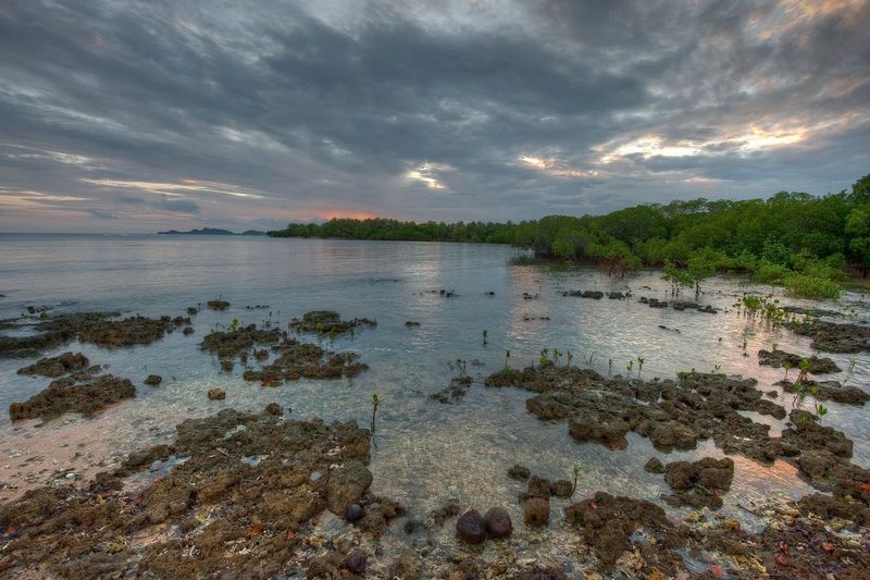 SUNSET AT LUTES.jpg :: VILLAGE OF LUTES - ULEVEO ISLAND.  MASKELYNE ISLAND GROUP, VANUATU.      
Sunset paints the sky and water as the tide pulls back from the coral reefs of the Maskelyne Islands. The extensive and pristine coral reefs and native people of the Maskelynes are experiencing serious threats due to changes in sea levels and temperature. 