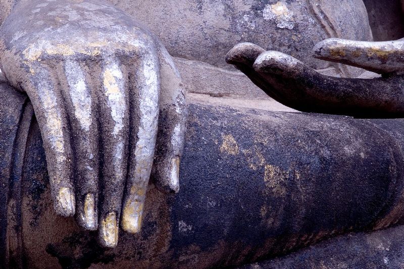 TOUCHING EARTH.jpg :: WAT MAHATHAT, SUKHOTHAI, THAILAND.    
This classic gesture represents Buddhas last moments before enlightenment and bears witness to innumerable Buddhist worshipers


