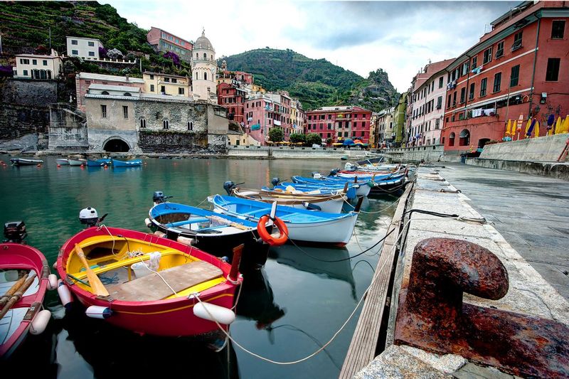 VERNAZZA DAWN.jpg :: LIGURIAN COAST.  VERNAZZA, ITALY.  Small skiffs that make up the fishing fleet of Vernazza shift slowly with tidal rhythms of the Ligurian Coast. At dawn the boats have been cleaned, the nets safely stowed, and the oars positioned carefully for another day at sea. Just as they have for centuries, the fishermen slip silently from the harbor each morning before the town stirs to life.