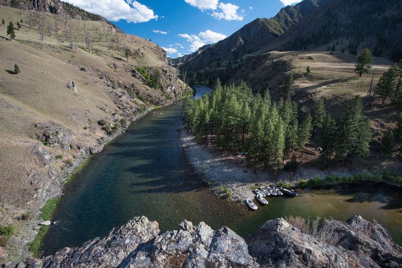SURVEY CREEK MIDDLE FORK SALMON.jpg :: SURVEY CREEK CAMP.  MIDDLE FORK OF THE SALMON, IDAHO.   A rafting party settles down for the afternoon at Survey Creek Camp nestled along the banks of the Middle Fork of the Salmon River which is regarded as one of the top wilderness whitewater runs in North America.  The Survey Creek area was historically used by native peoples for centuries and numerous sensitive archaeological sites and pictographs remain.