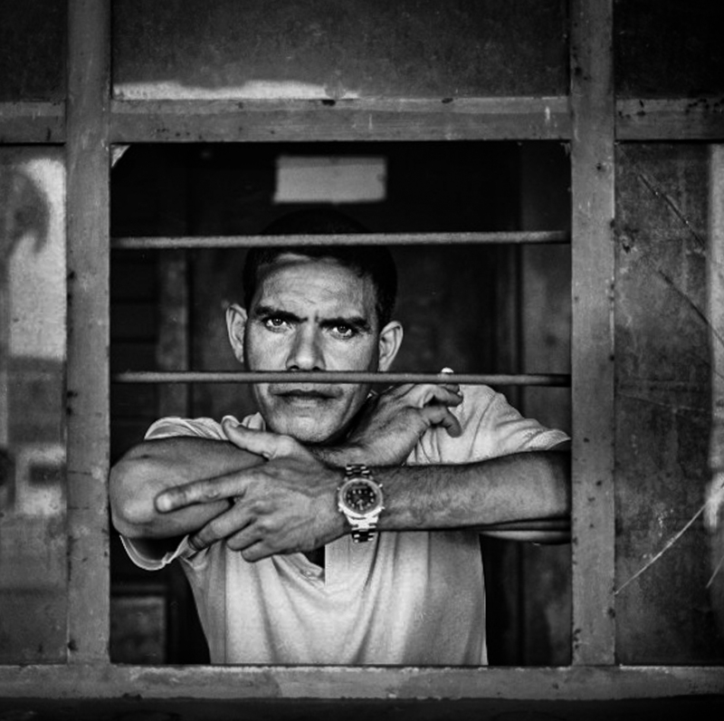 Cuba Man Glaring Barred Window-2.jpg