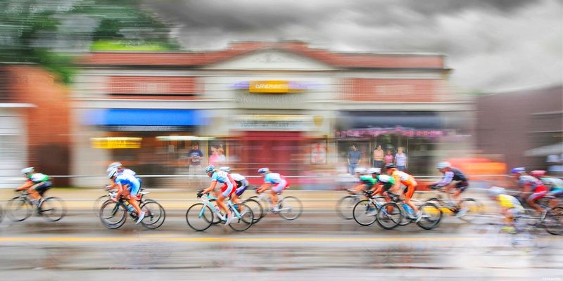 CaughtinTime.jpg :: Each summer on a designated weekend, the streets of Grandview transform to a blur of color as cyclists race through the city in the quest for a place on the winners podium of the Tour De Grandview.