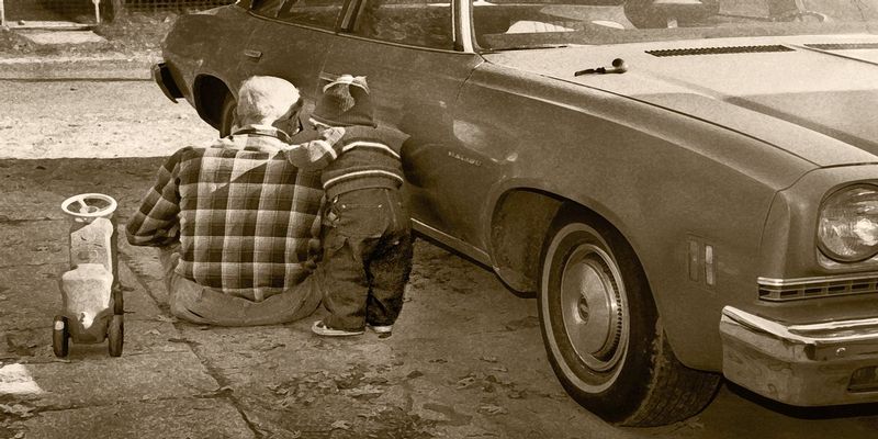 HelpingGrandpa.jpg :: My son taking some pointers from Grandpa on keeping your vehicle running properly. 