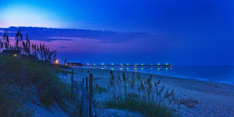 OBX_KDHPier.jpg ::  Warm sand between my toes, listening to the waves lap the shore on a beautiful, still summer evening - this is the pier at Kill Devil Hills from behind our cottage on the beach.