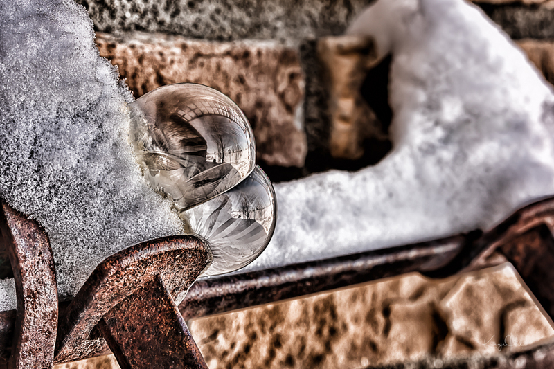 Double Bubble.jpg :: Frozen fingers of ice and sugar crystals form on soap bubbles on an old piece of patinated farm equipment - deep winter in Colorado, USA.
