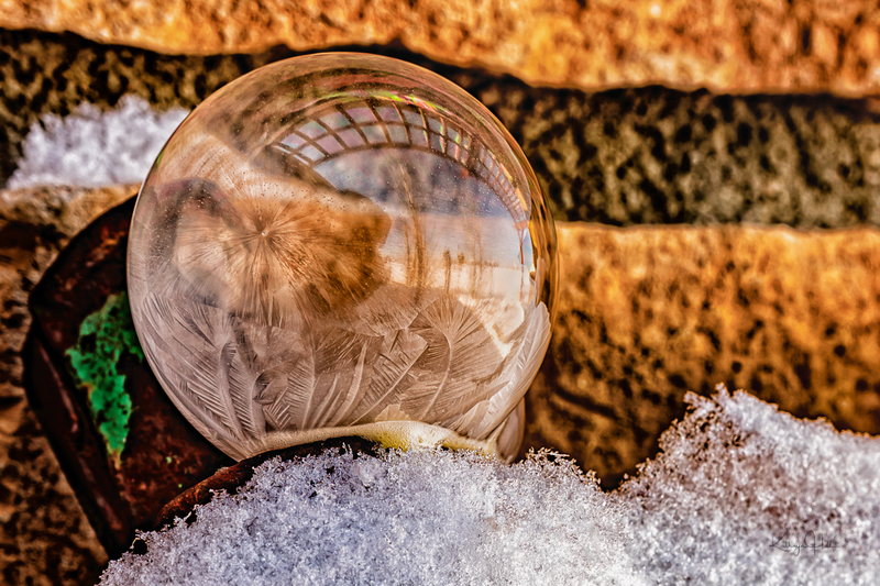 Feathery Frosty Bubble(1).jpg :: Frozen fingers of ice and sugar crystals form on a soap bubble on an old piece of patinated farm equipment - deep winter in Colorado, USA.