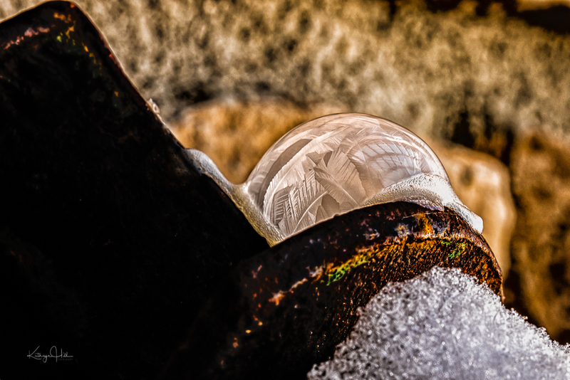 Rusty Bubble.jpg :: Frozen fingers of ice and sugar crystals form on a soap bubble on an old piece of patinated farm equipment - deep winter in Colorado, USA.