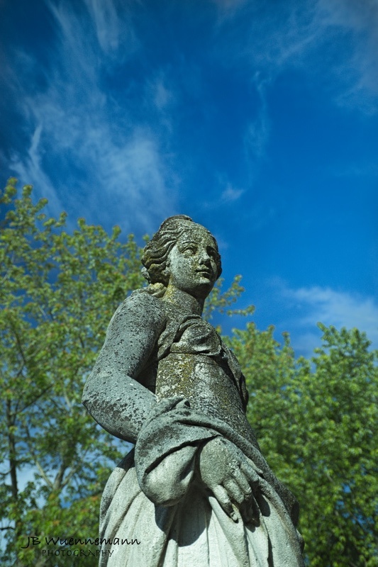 Female Statue in Blue Sky_1.jpg :: Stone statue with blue skies and green trees at Toledo Botanical Gardens.