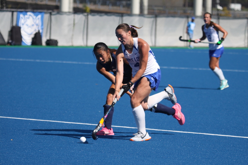 IMG_0421(3).jpg :: Saint Louis University (SLU) Women's Field Hockey vs University of California Davis 2025 at the SLU Field Hockey Complex. UC Davis won 2 to 1. The UC Davis players are wearing pink shoes and there are Pink Ribbons painted on the players sticks. Today is Billikens Pink Game for Breast Cancer Awareness and Alumnae Day. This is the second season at the new SLU Field Hockey Complex, and it marks, the 50th anniversary of the St. Louis University Field Hockey program which began in 1975. NCAA Division I 