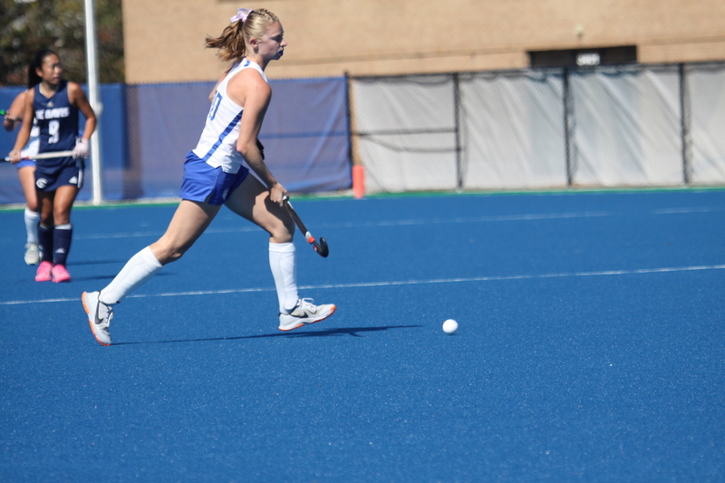 Saint Louis University (SLU) Field Hockey vs UC Davis 2025 XXX.jpg :: SLU Field Hockey vs University of California Davis at the SLU Field Hockey Complex - Women's Field Hockey - The standard field size for field hockey is 300 feet (100 meters) long and 167 feet wide. A field hockey field's boundaries are marked with the end lines going across the width and sidelines going across the length. - The field is divided into quarters by four lines. The 25-yard line are 25 yards from each end line, and the center line runs through the middle of the field. The goalposts are 12 feet wide, 7 feet tall, and 4 feet deep. Each goal post is situated in the center of each end line. - The Striking Circle is a Semi-Circle with a radius of around 48 feet surrounding each goal. - There are always 22 players on the field, 11 from each team. Each team has a goalkeeper and 10 fielders.
