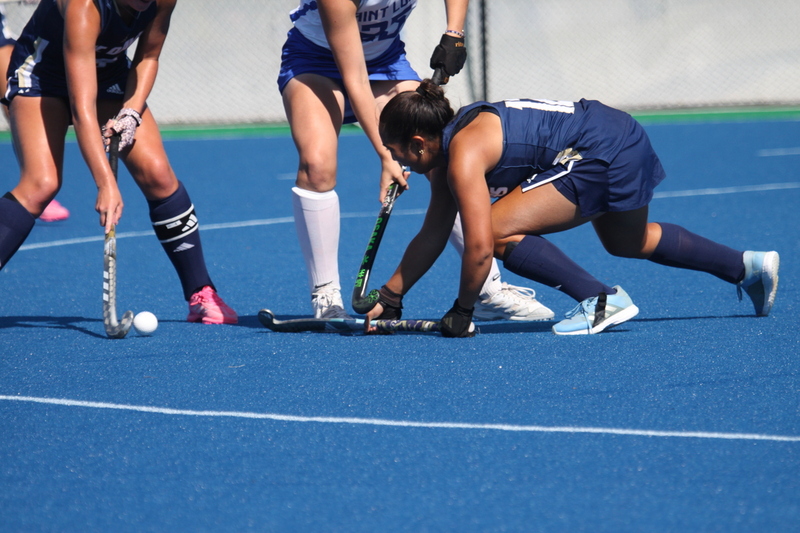 Saint Louis University (SLU) Field Hockey vs UC Davis 2025 XXXXVIII.jpg :: SLU Field Hockey vs University of California Davis at the SLU Field Hockey Complex - Women's Field Hockey - The standard field size for field hockey is 300 feet (100 meters) long and 167 feet wide. A field hockey field's boundaries are marked with the end lines going across the width and sidelines going across the length. - The field is divided into quarters by four lines. The 25-yard line are 25 yards from each end line, and the center line runs through the middle of the field. The goalposts are 12 feet wide, 7 feet tall, and 4 feet deep. Each goal post is situated in the center of each end line. - The Striking Circle is a Semi-Circle with a radius of around 48 feet surrounding each goal. - There are always 22 players on the field, 11 from each team. Each team has a goalkeeper and 10 fielders.