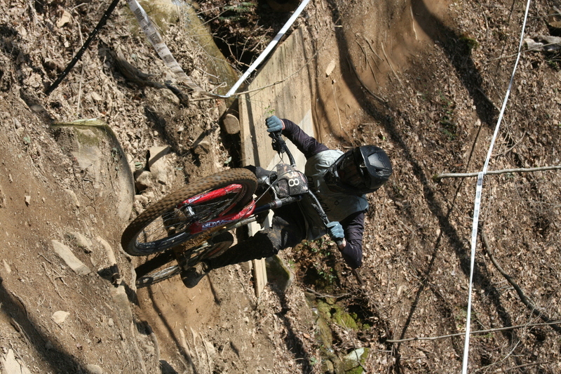 Tennessee National Mountain Bike Festival 2023 LXXIX.jpg :: Tennessee National 2023 - Tennessee Mountain Bike Festival 2023 - Windrock Bicycle Park in Oliver Springs, Tennessee, USA. Mountain Bike Downhill on the wooded trail in hills of Tennessee. Fast downhill action with aerials throughout the run. Red Bull gives you wings. 