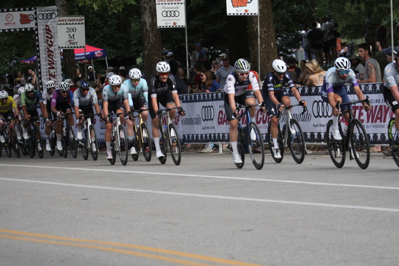 Tour De Francis Park 2025 E -LVII.jpg :: Tour de Francis Park 2025/Gateway Cup 2025 - Men's Pro CAT 1, 70 minutes race, 150 rider field - Tour de Francis Park! Francis Park, named after David Rowland Francis - President of the Louisiana Purchase Exposition (the 1904 World's Fair) is known for its wide, tree lined streets and for having beautiful churches on every corner. Today the St. Louis Hills neighborhood showcases gingerbread bungalows, stately homes and some of the tidiest landscaping in St. Louis. - (Gateway Cup website) - Peloton - in a bicycle race, the term - peloton - refers to the main group of riders, also known as the -pack- or -bunch-. Riders race in a pack to draft, which means they ride closely together to save energy and improve speed. (Google) This is a USA Cycling sanctioned race event. 