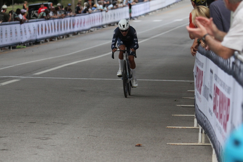 Tour De Francis Park 2025 E -LXV.jpg :: Tour de Francis Park 2025/Gateway Cup 2025 - Men's Pro CAT 1, 70 minutes race, 150 rider field - Tour de Francis Park! Francis Park, named after David Rowland Francis - President of the Louisiana Purchase Exposition (the 1904 World's Fair) is known for its wide, tree lined streets and for having beautiful churches on every corner. Today the St. Louis Hills neighborhood showcases gingerbread bungalows, stately homes and some of the tidiest landscaping in St. Louis. - (Gateway Cup website) - Peloton - in a bicycle race, the term - peloton - refers to the main group of riders, also known as the -pack- or -bunch-. Riders race in a pack to draft, which means they ride closely together to save energy and improve speed. (Google) This is a USA Cycling sanctioned race event. 