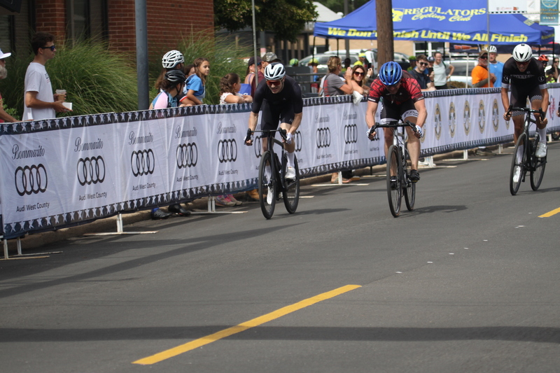 Tour de Florissant 2025 A -XXXX.jpg :: Tour de Florissant 2025/Gateway Cup 2025, 2025 - September 1st- Men's Cat 4/5, 40 minutes of racing, a field of 75 riders - Tour de Florissant - New course for 2025! The fourth and final leg of the Gateway Cup gets underway in Historic Old Town Florissant in St. Louis County. This technical course races through one of St. Louis' most nostalgic locales. Note - the course has been shifted to a flat finish in front of Historic City Hall, one mild climb, 6 turns. Category 4 (CAT 4) After gaining some experience, riders can upgrade to CAT 4, where races are longer and more competitive. USA Cycling, Big Shark Bicycle Company, Bommarito Audi West County