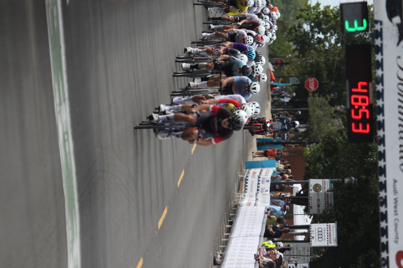 Tour de Florissant 2025 F -XXXII.jpg :: Tour de Florissant 2025 - Gateway Cup 2025 - September 1st 2025 - Men's CAT 2-3, 55 Minutes of racing, a field of 150 racers - Tour de Florissant - New course for 2025! The fourth and final leg of the Gateway Cup gets underway in Historic Old Town Florissant in St. Louis County. This technical course races through one of St. Louis' most nostalgic locales. Note - the course has been shifted to a flat finish in front of Historic City Hall, one mild climb, 6 turns. Gateway Cup website - In mass start cycling racers, the winner is determined by the first rider to cross the finish line. However, the race format can vary, and some events may have additional criteria or rules that can influence the winner. For example, in points races, the rider with the most points at the end of the race wins, and in sprint events, the winner is determined by the third rider to cross the finish line after a series of sprints. Wikipedia - The slower riders will be asked to exit the racecourse if not on the lead lap with five laps to go. This is to not interrupt the lead lap riders that are going to have the hard fast finish. Riders in lower categories are given one lap to go with two or three laps to go. This determines the winner of the lower category race in mass start race finishes for this event. Pace motorcycles help keep track of slower riders and categories. Given a number and riders to watch. 