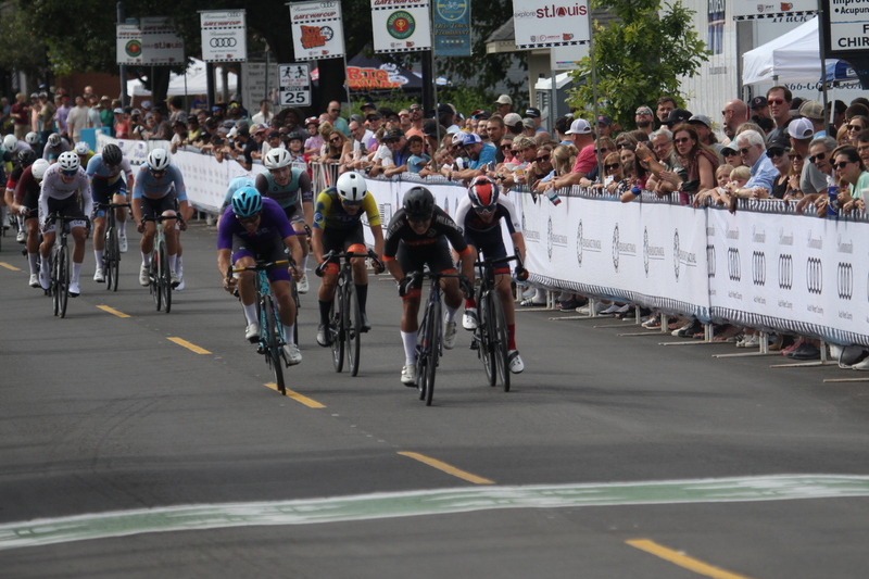 Tour de Florissant 2025 F -XXXXII.jpg :: Tour de Florissant 2025 - Gateway Cup 2025 - September 1st 2025 - Men's CAT 2-3, 55 Minutes of racing, a field of 150 racers - Tour de Florissant - New course for 2025! The fourth and final leg of the Gateway Cup gets underway in Historic Old Town Florissant in St. Louis County. This technical course races through one of St. Louis' most nostalgic locales. Note - the course has been shifted to a flat finish in front of Historic City Hall, one mild climb, 6 turns. Gateway Cup website - In mass start cycling racers, the winner is determined by the first rider to cross the finish line. However, the race format can vary, and some events may have additional criteria or rules that can influence the winner. For example, in points races, the rider with the most points at the end of the race wins, and in sprint events, the winner is determined by the third rider to cross the finish line after a series of sprints. Wikipedia - The slower riders will be asked to exit the racecourse if not on the lead lap with five laps to go. This is to not interrupt the lead lap riders that are going to have the hard fast finish. Riders in lower categories are given one lap to go with two or three laps to go. This determines the winner of the lower category race in mass start race finishes for this event. Pace motorcycles help keep track of slower riders and categories. Given a number and riders to watch. 