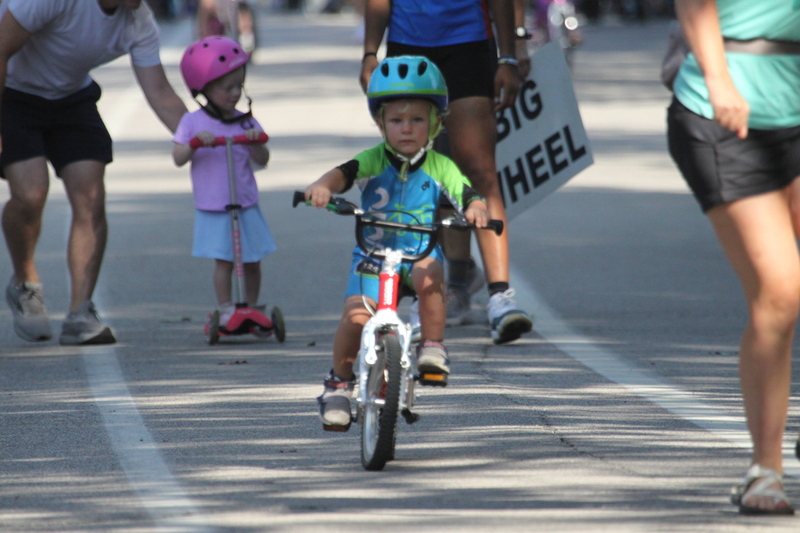 Tour de Francis Park 2025 C -LXXXIX.jpg :: Tour de Francis Park 2025/Gateway Cup 2025 - Big Wheel (Toddler) to 12 years old, youth races. Tour de Francis Park! Francis Park, named after David Rowland Francis - President of the Louisiana Purchase Exposition (the 1904 World's Fair) is known for its wide tree lined streets and for having beautiful churches on every corner. Today the St. Louis Hills neighborhood showcases gingerbread bungalows, stately homes and some of the tidiest landscaping in St. Louis. The youth races are held during the day of racing. The main event racing happens after the yoouth races. So the crowd see the future of the sport of cycling as it's forming.  