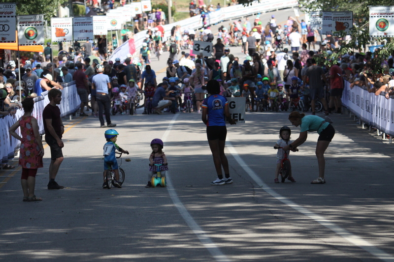 Tour de Francis Park 2025 C -LXXXVI.jpg :: Tour de Francis Park 2025/Gateway Cup 2025 - Big Wheel (Toddler) to 12 years old, youth races. Tour de Francis Park! Francis Park, named after David Rowland Francis - President of the Louisiana Purchase Exposition (the 1904 World's Fair) is known for its wide tree lined streets and for having beautiful churches on every corner. Today the St. Louis Hills neighborhood showcases gingerbread bungalows, stately homes and some of the tidiest landscaping in St. Louis. The youth races are held during the day of racing. The main event racing happens after the yoouth races. So the crowd see the future of the sport of cycling as it's forming.  