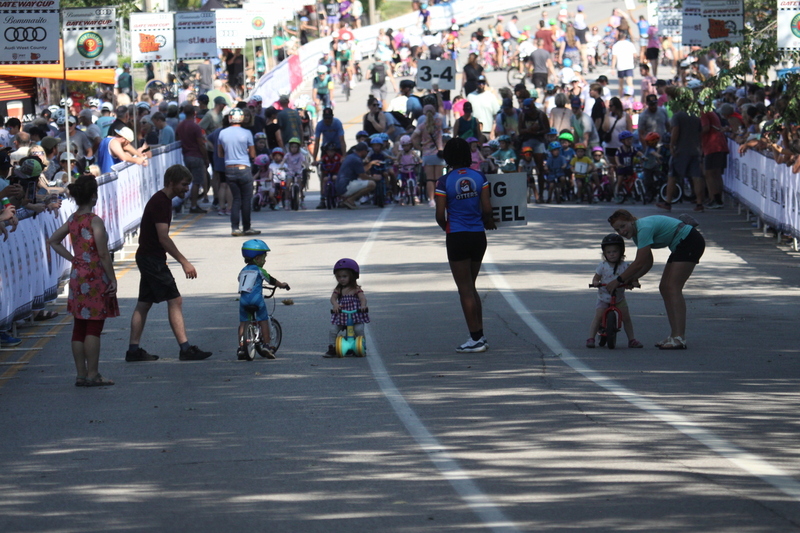 Tour de Francis Park 2025 C -LXXXVII.jpg :: Tour de Francis Park 2025/Gateway Cup 2025 - Big Wheel (Toddler) to 12 years old, youth races. Tour de Francis Park! Francis Park, named after David Rowland Francis - President of the Louisiana Purchase Exposition (the 1904 World's Fair) is known for its wide tree lined streets and for having beautiful churches on every corner. Today the St. Louis Hills neighborhood showcases gingerbread bungalows, stately homes and some of the tidiest landscaping in St. Louis. The youth races are held during the day of racing. The main event racing happens after the yoouth races. So the crowd see the future of the sport of cycling as it's forming.  