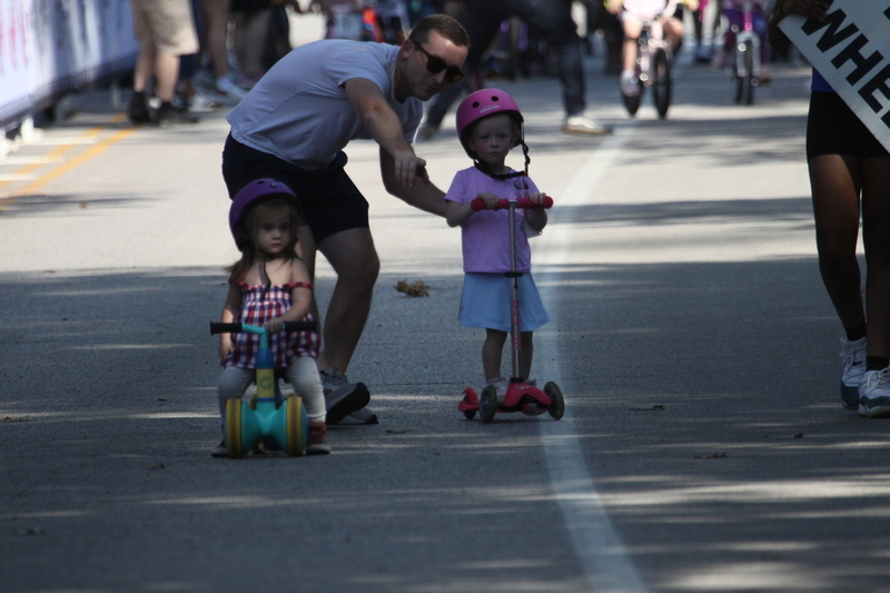 Tour de Francis Park 2025 C -LXXXVIII.jpg :: Tour de Francis Park 2025/Gateway Cup 2025 - Big Wheel (Toddler) to 12 years old, youth races. Tour de Francis Park! Francis Park, named after David Rowland Francis - President of the Louisiana Purchase Exposition (the 1904 World's Fair) is known for its wide tree lined streets and for having beautiful churches on every corner. Today the St. Louis Hills neighborhood showcases gingerbread bungalows, stately homes and some of the tidiest landscaping in St. Louis. The youth races are held during the day of racing. The main event racing happens after the yoouth races. So the crowd see the future of the sport of cycling as it's forming.  