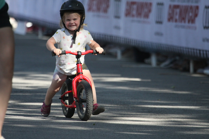 Tour de Francis Park 2025 C -LXXXX.jpg :: Tour de Francis Park 2025/Gateway Cup 2025 - Big Wheel (Toddler) to 12 years old, youth races. Tour de Francis Park! Francis Park, named after David Rowland Francis - President of the Louisiana Purchase Exposition (the 1904 World's Fair) is known for its wide tree lined streets and for having beautiful churches on every corner. Today the St. Louis Hills neighborhood showcases gingerbread bungalows, stately homes and some of the tidiest landscaping in St. Louis. The youth races are held during the day of racing. The main event racing happens after the yoouth races. So the crowd see the future of the sport of cycling as it's forming.  