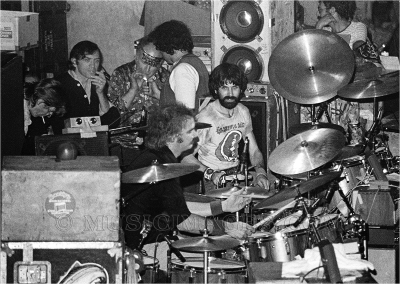 B295-31.jpg :: Drummers Bill Kreutzmann & Mickey Hart...plus Phil Lesh, Bill Graham, Ken Kesey and Steve Parish light up behind them.  Winterland, San Francisco, Ca. 12/31/77