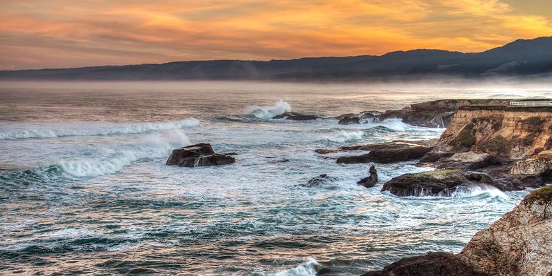 Waves and Flames.jpg :: A late winter sunrise on the Mendocino coast. The sky burns with flames in the clouds, while the ice blue waves beat upon the stone shore.