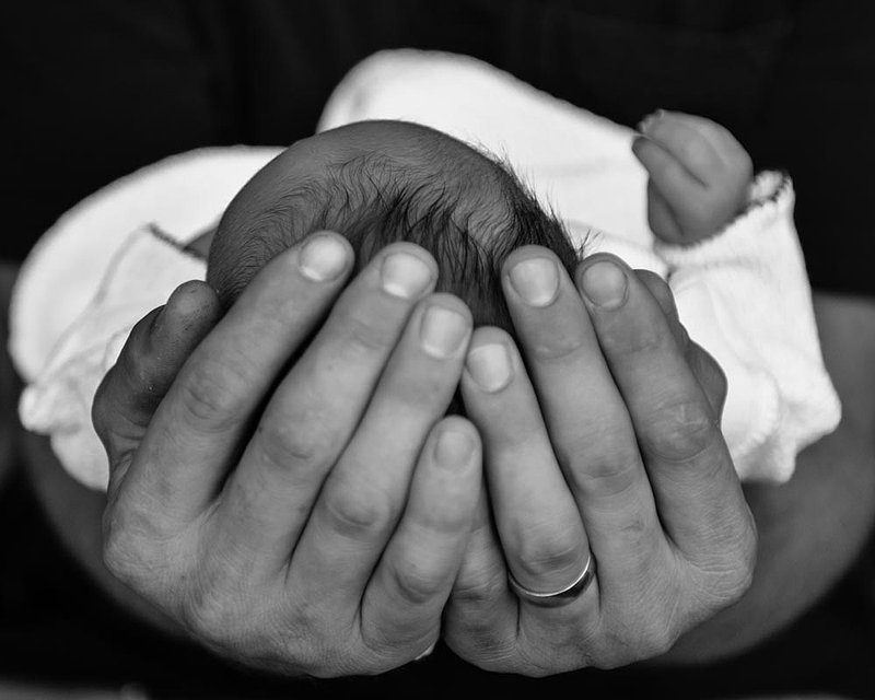 Dad cradling newborn.jpg