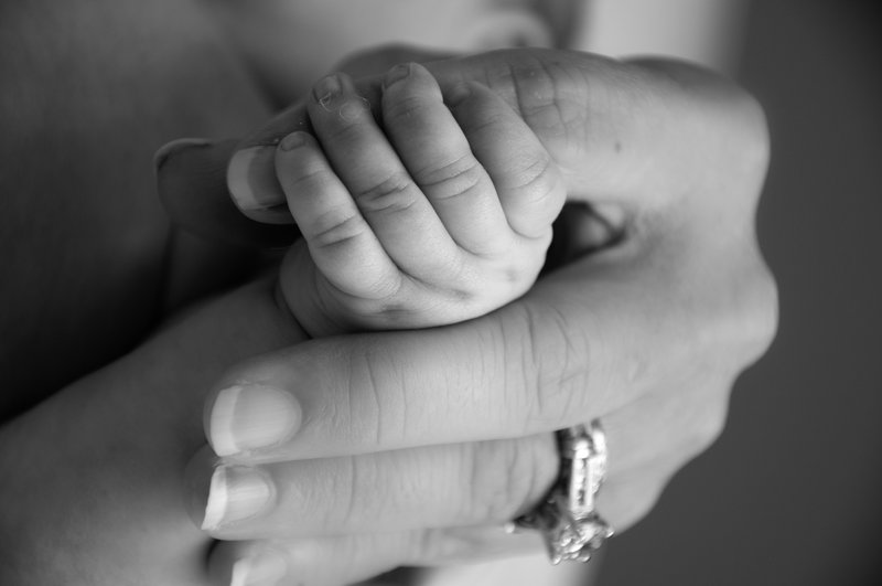 Newborn holding hand.jpg