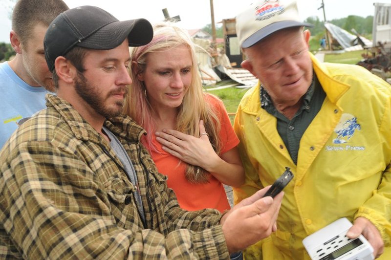 041127  ALA STORMS_001.jpg :: Shane Hale, sister and Elton Hale look at a video that Shane shot  of the tornado that hit their neighborhood as Alabama was hit by numerous storms Wednesday April 27, 2011.      (The Birmingham News/ Hal Yeager)