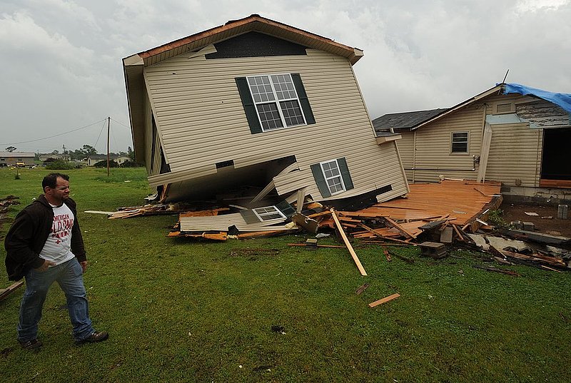 041127  ALA STORMS_002.jpg :: Elton Hale walks past his house on Pearson street in Fairview in Cullman county that was hit by a tornado as Alabama  was hit by numerous storms Wednesday April 27, 2011.      (The Birmingham News/ Hal Yeager)