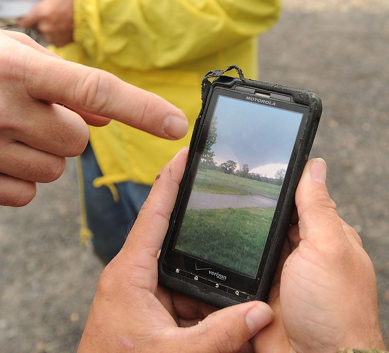 041127  ALA STORMS.jpg :: Shane Hale looks at a video he shot of the tornado that hit their neighborhood in Fairview in Cullman county that was hit by a tornado as Alabama  was hit by numerous storms Wednesday April 27, 2011.      (The Birmingham News/ Hal Yeager)