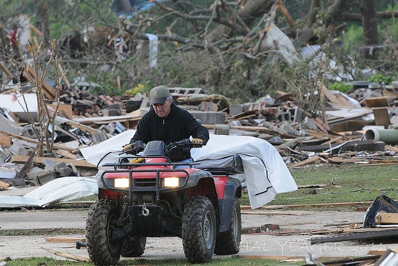 041128 ALABAMA TORNADOES_001.jpg :: A man uses a four wheeler as he takes a body to a coroner's van in Concord, Ala. Thursday April 28, 2011. (The Birmingham News/Hal Yeager)